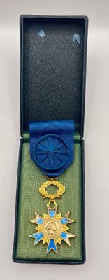 a blue box with a gold medal and a blue ribbon