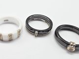 three black and white rings on a white surface