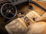 beige leather interior of a car with a steering wheel and dashboard