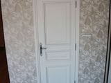 a white door and a black floor in a room