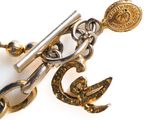 a close up of a key and a chain on a white surface