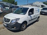 a white van that is parked on the side of the road