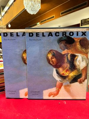 Deux livres sont posés sur une table rouge dans un magasin.