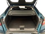 the back of a car with the trunk open and the back seats folded down