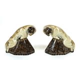 pair of ceramic figurines of a monkey and a monkey on a tree stump