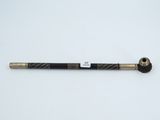 un stylo noir et or posé sur une surface blanche
