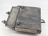 an old metal box that is sitting on a white surface