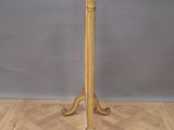 an image of a gold table with a marble top on a parquet floor
