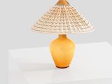 a yellow lamp that is on a white table