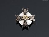 a cross with a skull on it on a black surface