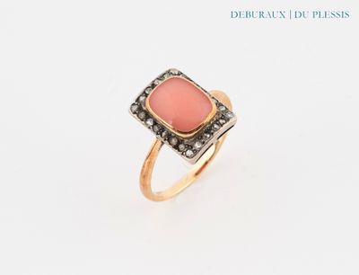a close up of a ring with a pink stone on it
