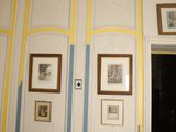 pictures hanging on the wall of a room with a doorway