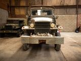 a old military truck parked in a garage