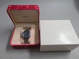 a box with a watch inside of it on a table