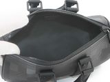 a cat that is sitting inside of a black bag