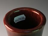 a brown vase that has a label on it