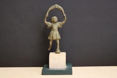 bronze statue of a girl holding a hoop on a marble base