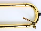 a gold colored metal object on a white surface