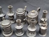 many different types of silver teapots on a table