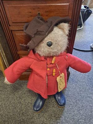 a teddy bear dressed in a red coat and hat