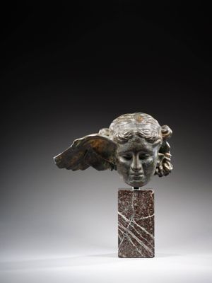 a close up of a statue of an angel on a marble base