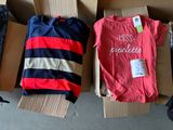several boxes of clothes are stacked on top of each other