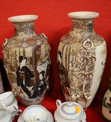 many vases and cups sitting on a red table