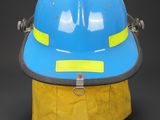 a close up of a blue hard hat with yellow tape on it