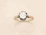 a diamond ring sitting on top of a table
