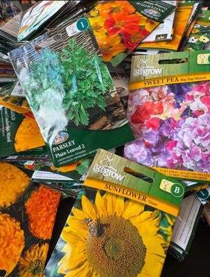 many seed packets of different types of flowers on the table