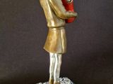 statue of a woman holding a red heart on a black background