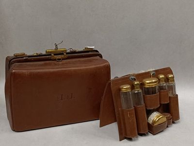 a brown leather case with six bottles of liquor in it