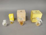 three small bottles of perfume sitting next to each other on a table