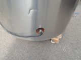 an image of a stainless steel tank with a hole in it