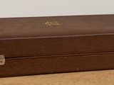 a brown suitcase sitting on top of a wooden table