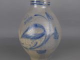 a blue and white vase sitting on a table