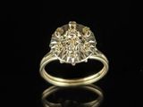 a close up of a gold ring with diamonds on a black surface