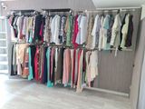 a rack of clothes hanging on a wall in a room