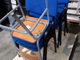 two blue chairs sitting on a pallet in a warehouse