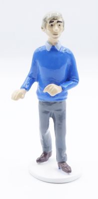 a figurine of a man with a blue shirt and gray pants