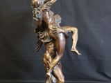 bronze statue of a man holding a woman on his back