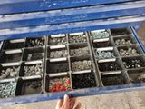 a blue tool box filled with lots of screws and nuts