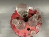 a red tray with glassware on top of it