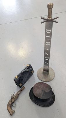 a gun, a hat, and a hat stand on the floor