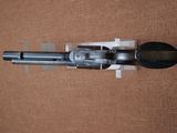 an image of a gun that is sitting on top of a brown surface