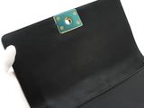 a hand holding a black leather wallet with a gold clasp