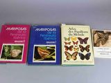 four books of different kinds of butterflies are lined up on a table