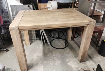 a wooden table with a white chair in the middle of it