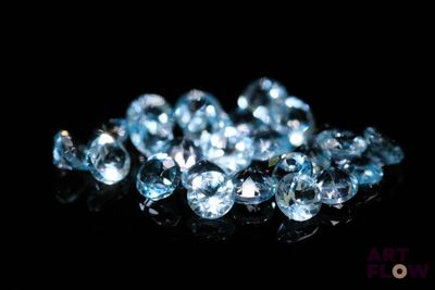 some very pretty blue diamonds on a black surface