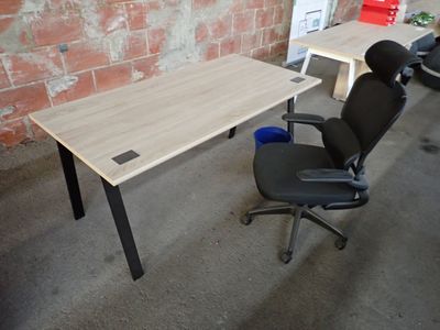 a desk with a chair and a computer on it